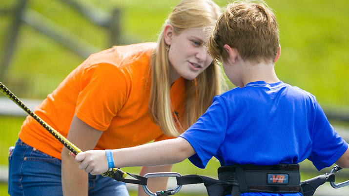 Summer employee talking to child