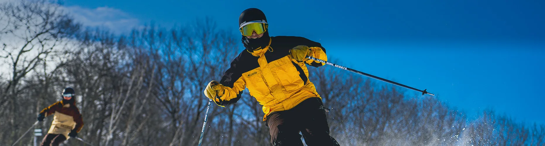 Skier in yellow jacket at Jiminy Peak